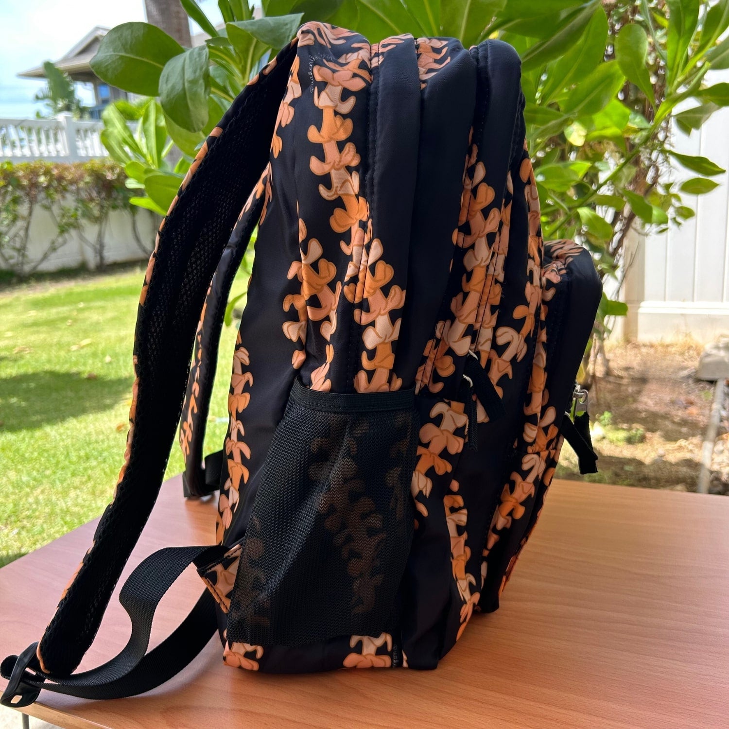 Backpack by Puakenikeni Designs, in the best selling and favorite pua kenikeni lei design, Kaulua, side view