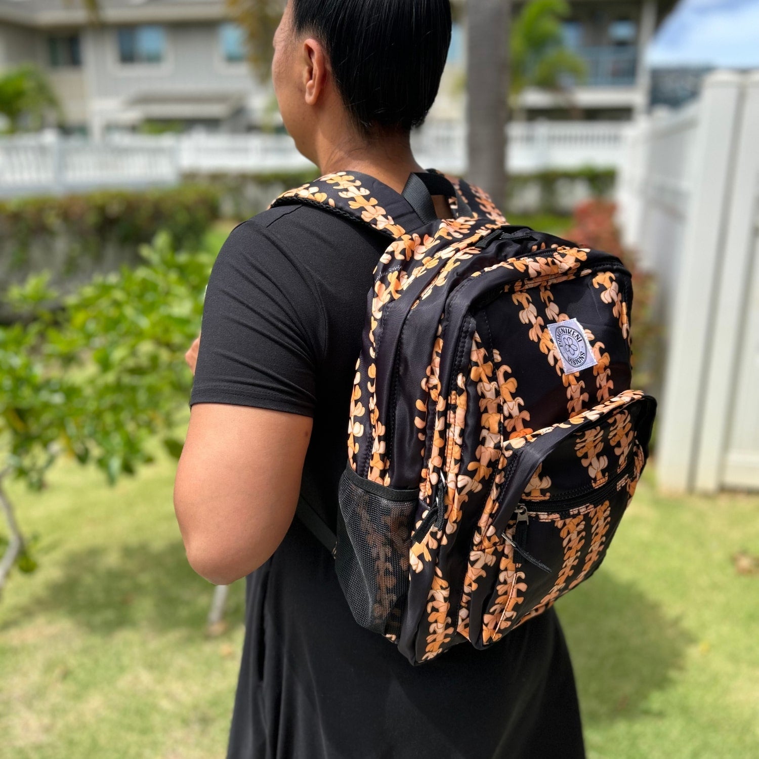 Backpack by Puakenikeni Designs, in the best selling and favorite pua kenikeni lei design, Kaulua, on model side view