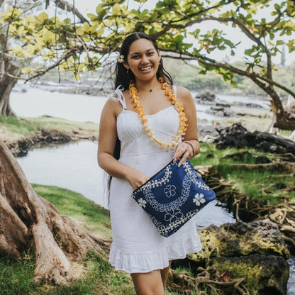 puakenikeni lei canvas zipper pouch with zipper in blue from Puakenikeni Designs model holding