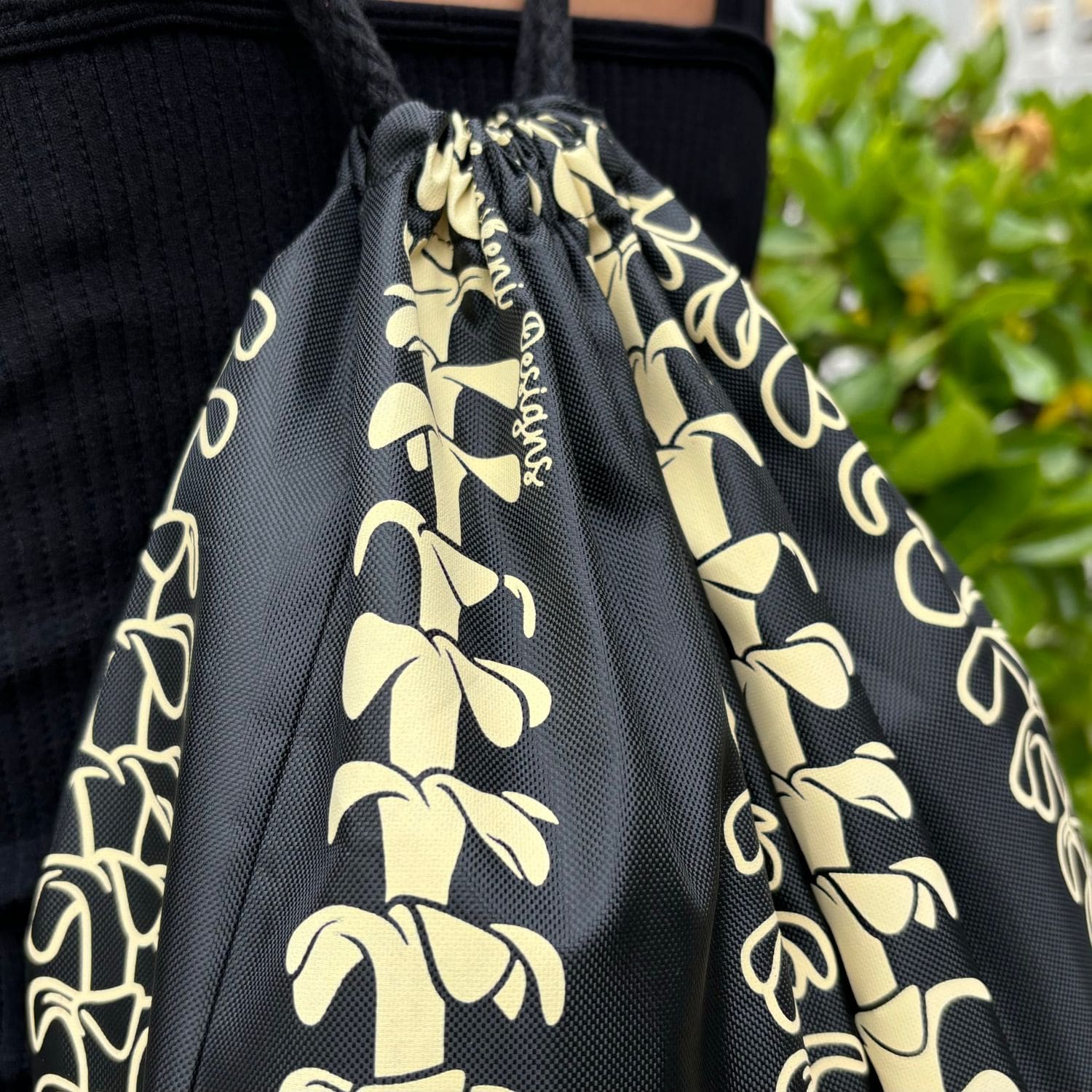 cinch drawstring backpack with pua kenikeni lei from Puakenikeni Designs closeup of top