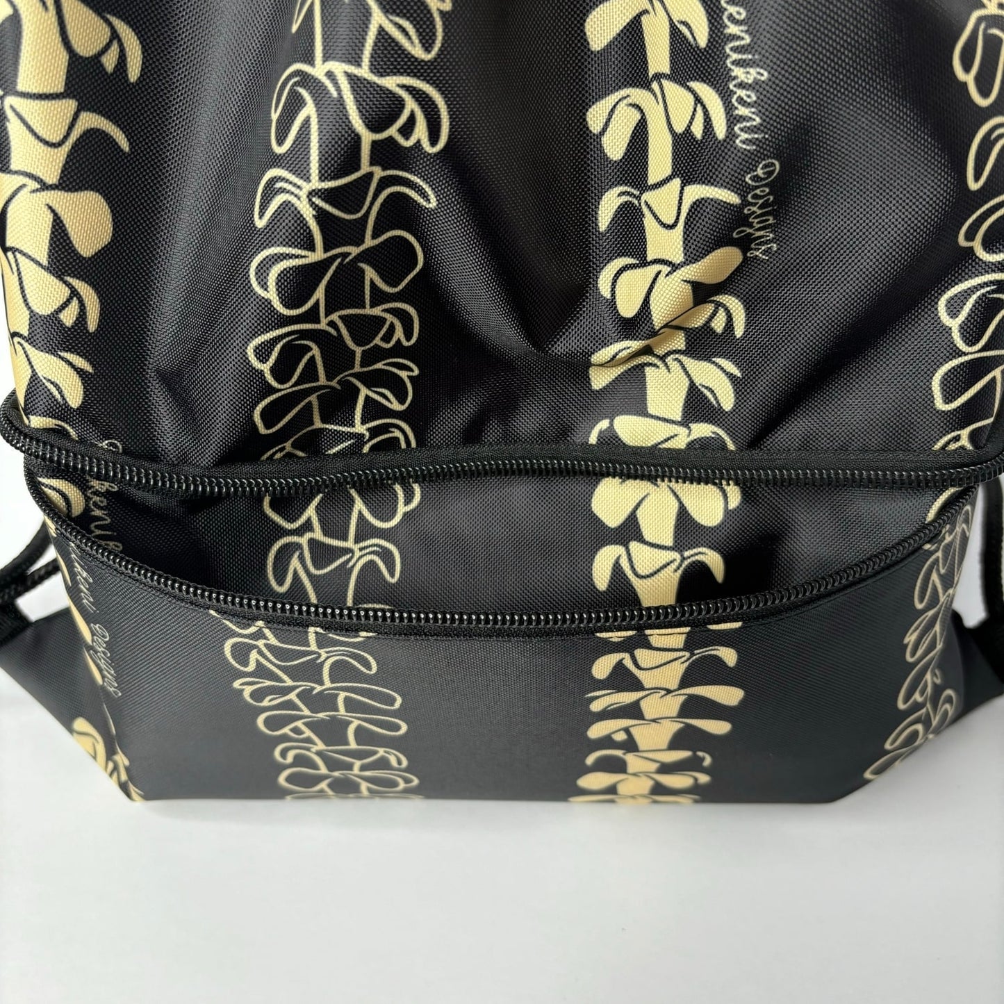 cinch drawstring backpack with pua kenikeni lei from Puakenikeni Designs Beige Lei close up front zippered pocket view