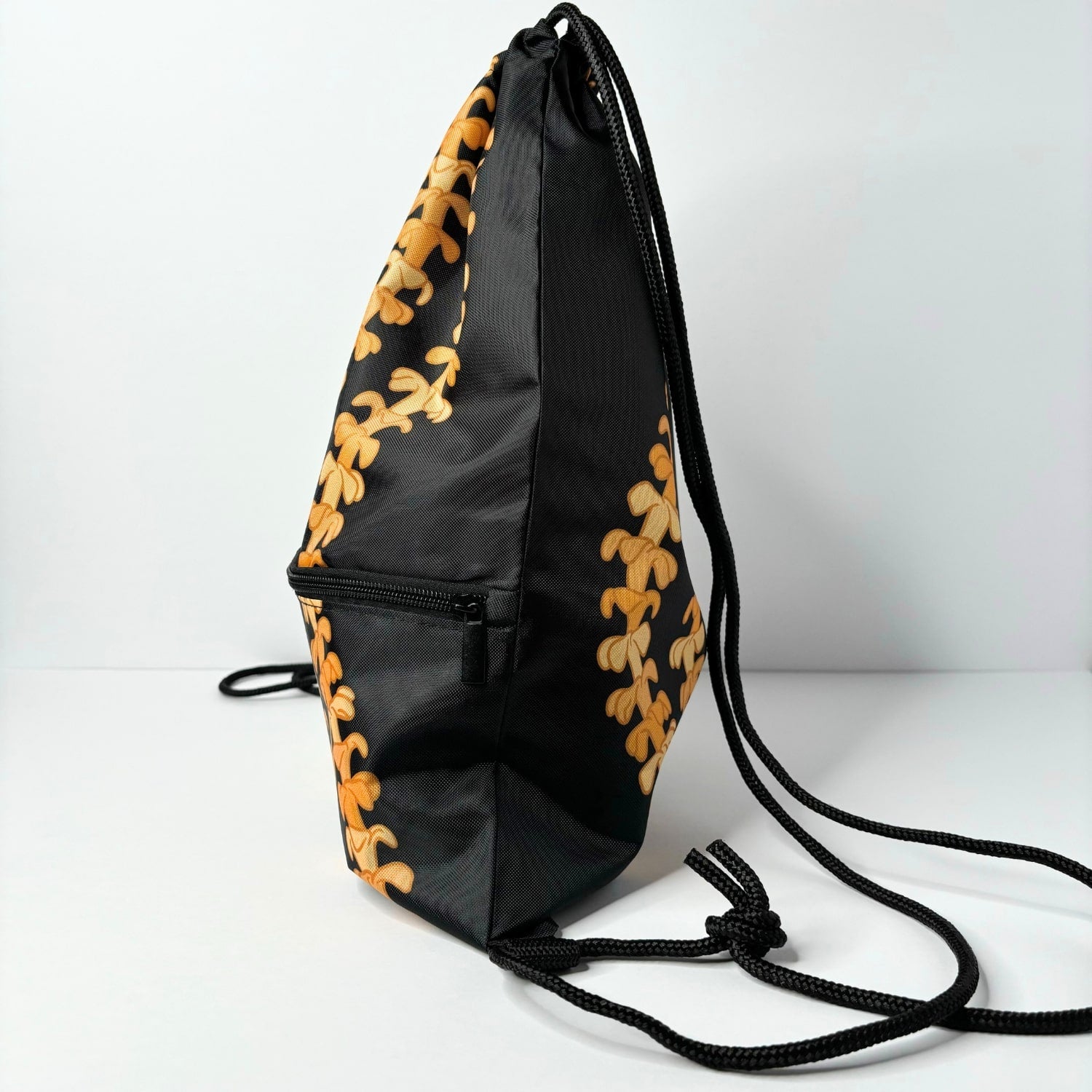 cinch drawstring backpack with pua kenikeni lei from Puakenikeni Designs Kaulua Black side view