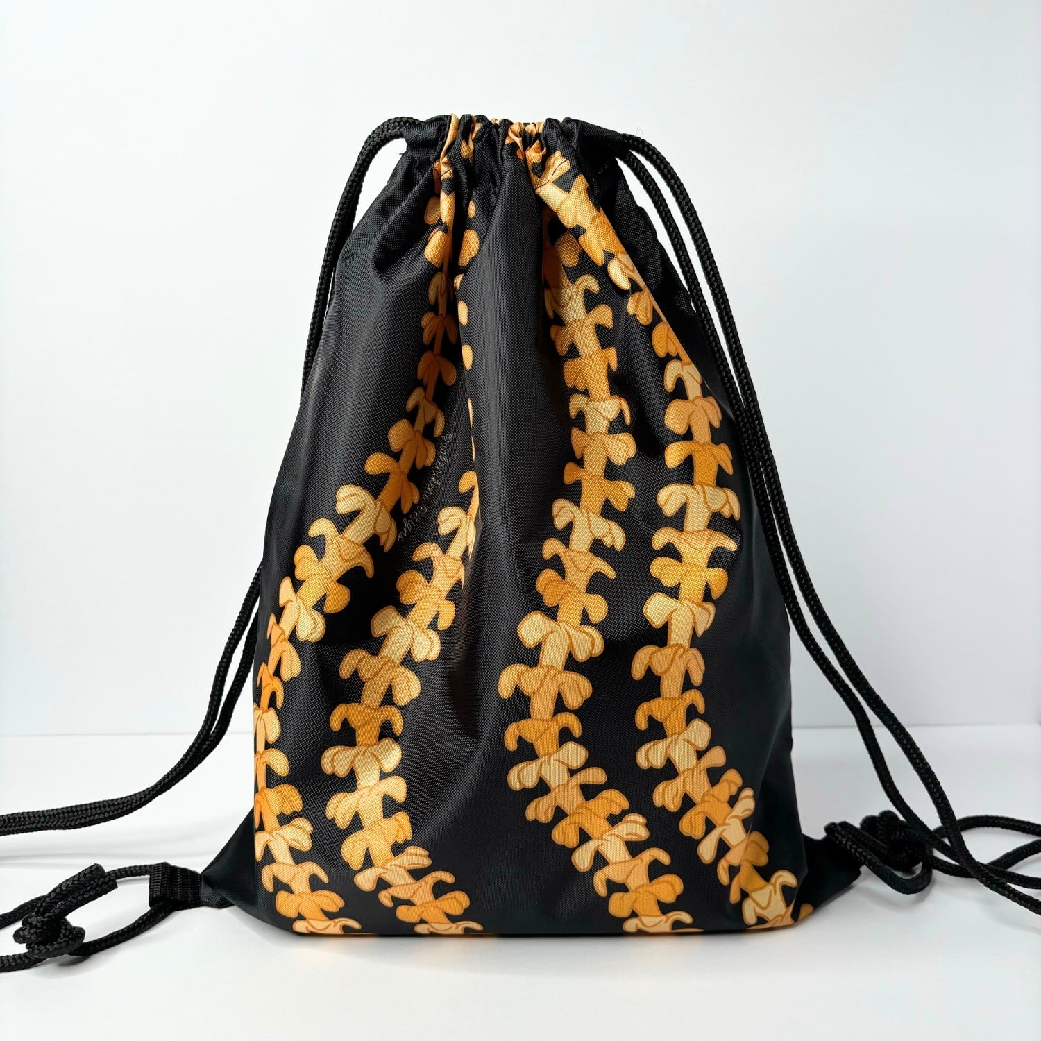 cinch drawstring backpack with pua kenikeni lei from Puakenikeni Designs Kaulua Black back view