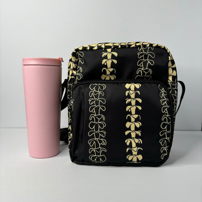 Crossbody bag by Puakenikeni Designs, in black with the best-selling pua kenikeni lei design, Kaulua; for women, moms, teenage girls, for travel and school Beige Lei Design next to 24 oz tumbler