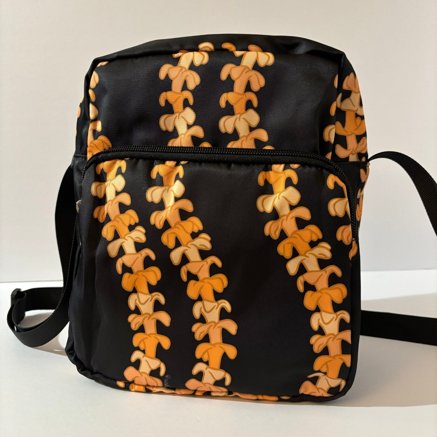 Crossbody bag by Puakenikeni Designs, in black with the best-selling pua kenikeni lei design, Kaulua; for women, moms, teenage girls, for travel and school