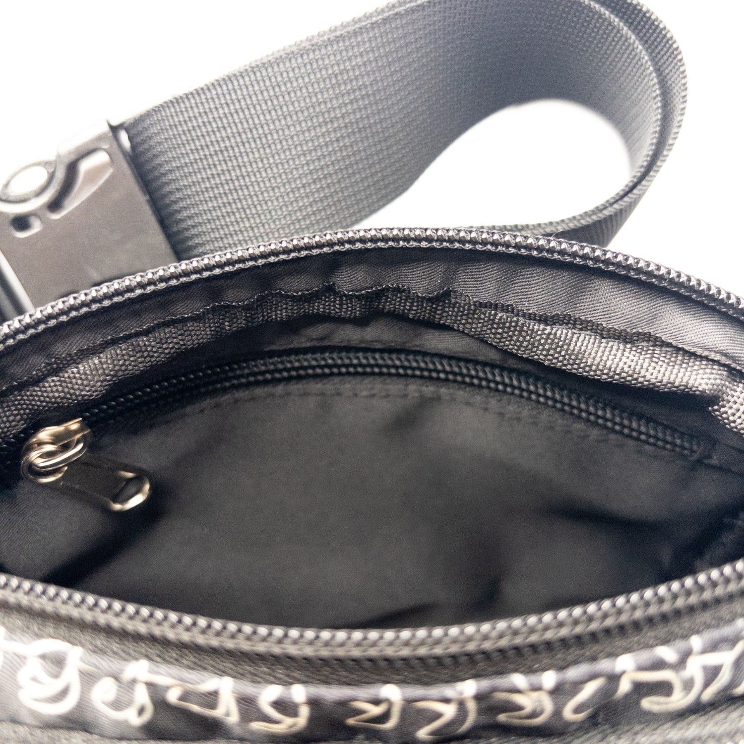 fanny pack, waist bag, belt bag, chest bag, hip pack, crossbody in pua kenikeni lei on black from Puakenikeni Designs top view inside zipper pocket