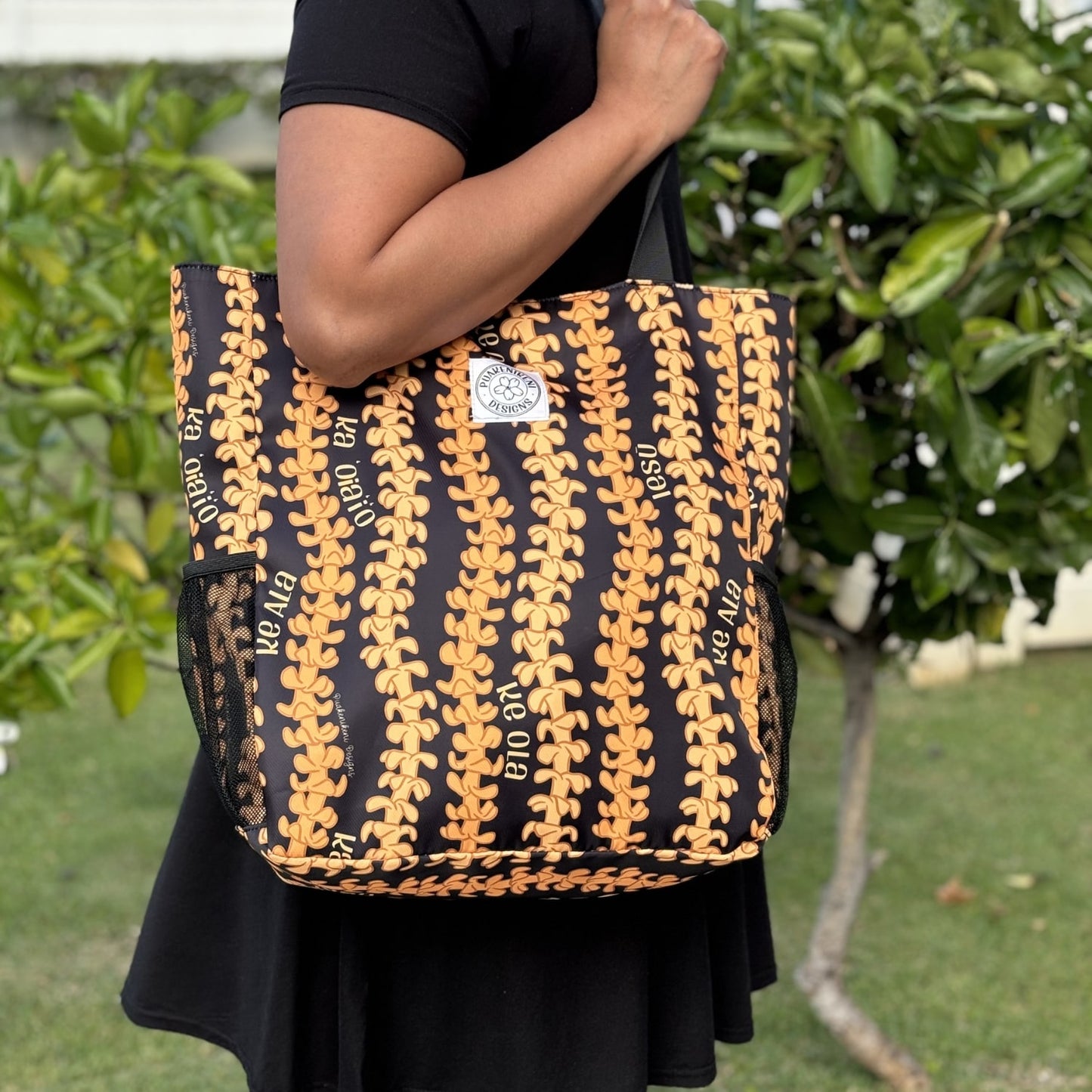 Holoholo Bag for travel, beach, hula, with puakenikeni lei Christian Faith collection by Puakenikeni Designs on shoulder of model