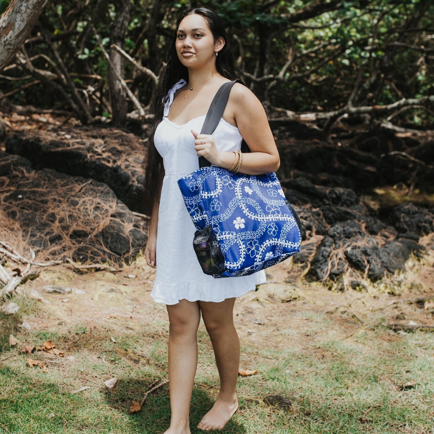 holoholo bag with pua kenikeni lei and flowers in blue from Puakenikeni Designs on model