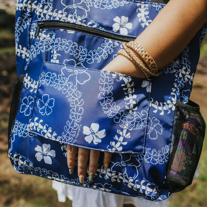 holoholo bag with pua kenikeni lei and flowers in blue from Puakenikeni Designs panel for sliding onto rolling carry-on luggage