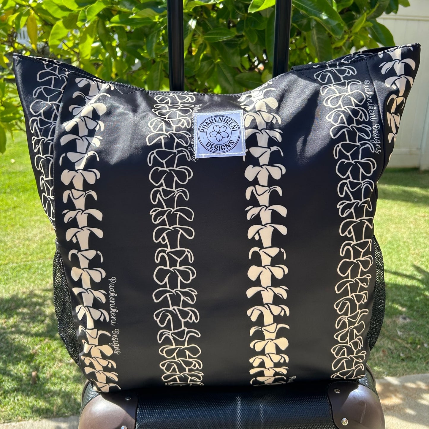 Holoholo Bag for travel from Puakenikeni Designs - use for beach, diaper bag, handbag, hula bag on a rolling suitcase