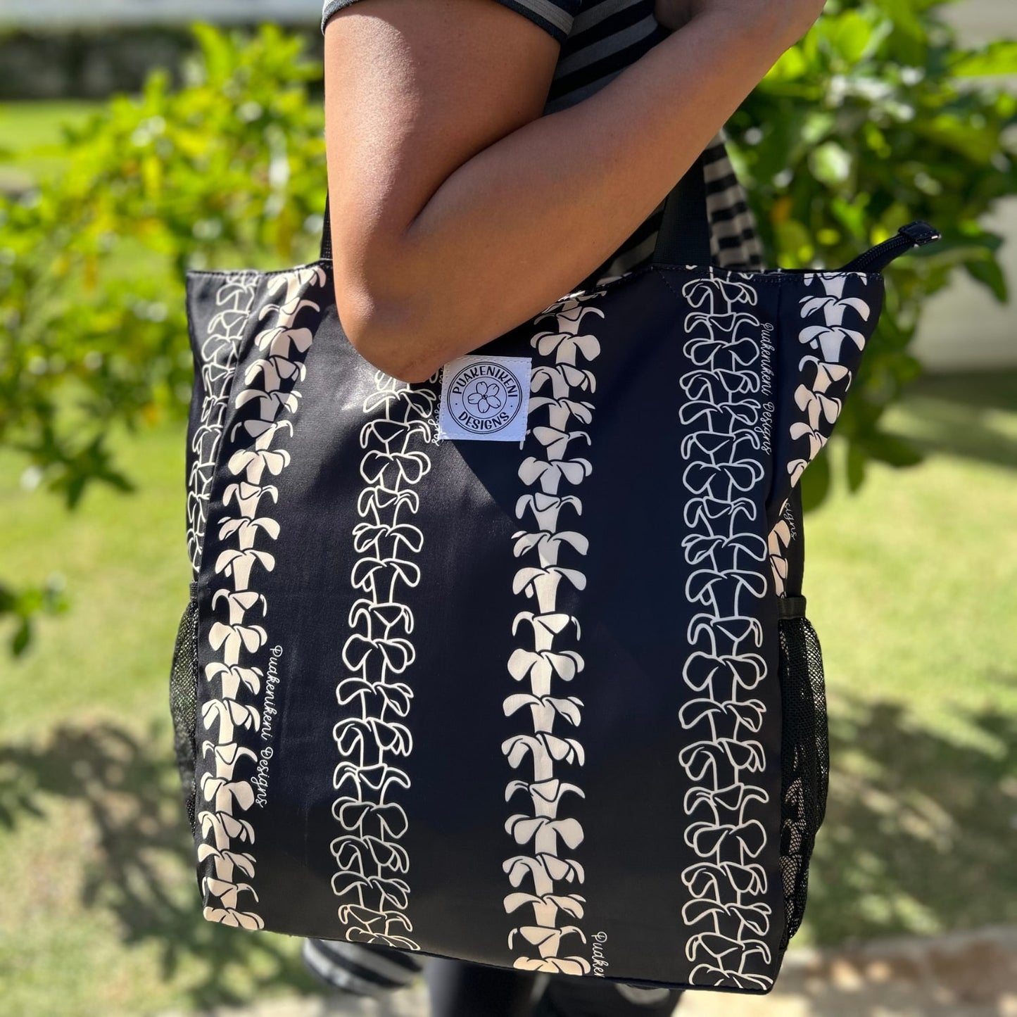 Holoholo Bag for travel from Puakenikeni Designs - use for beach, diaper bag, handbag, hula bag on model shoulder