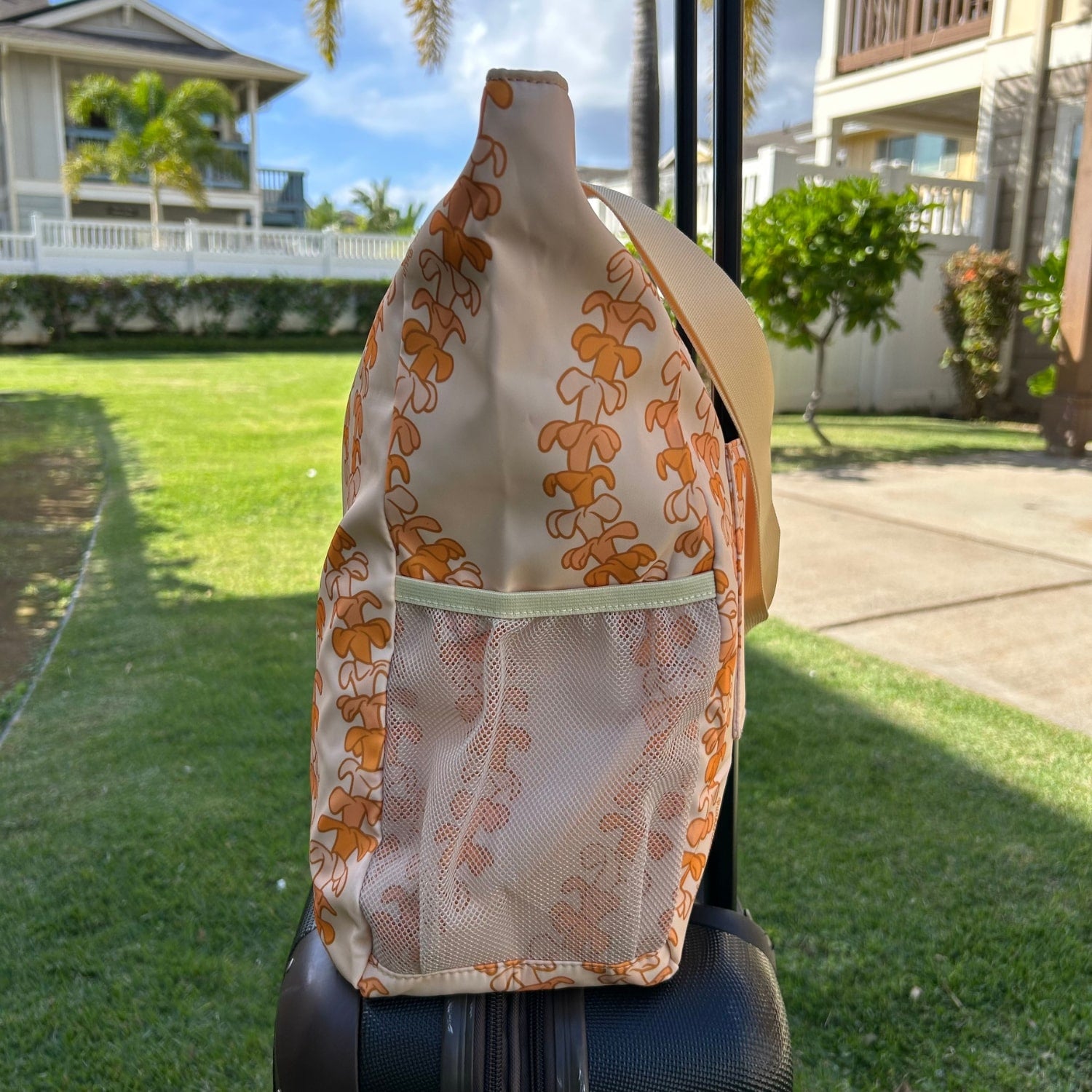 Most popular Holoholo bag in Kaulua light by Puakenikeni Designs - Made for Hawaii Puakenikeni tote bag side view slipped onto rolling luggage carry-on