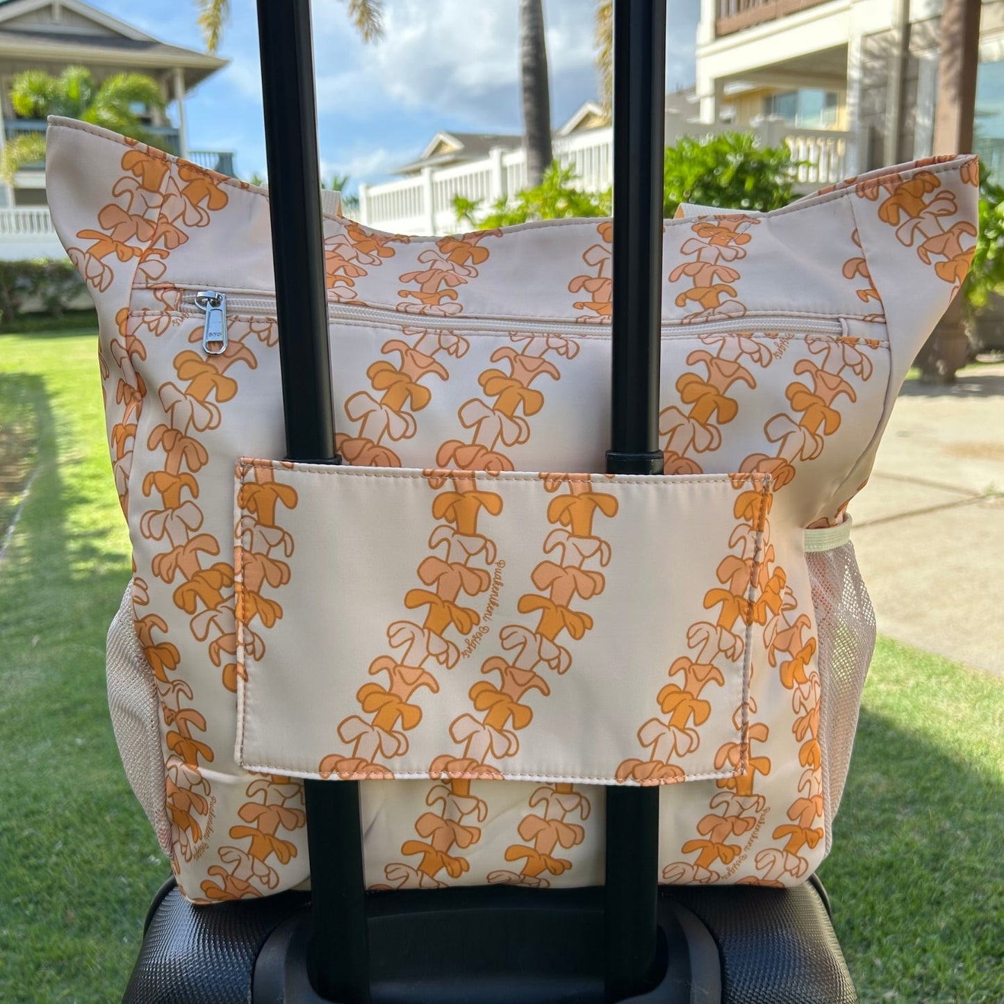 Most popular Holoholo bag in Kaulua light by Puakenikeni Designs - Made for Hawaii Puakenikeni tote bag backside slipped onto rolling luggage carry-on