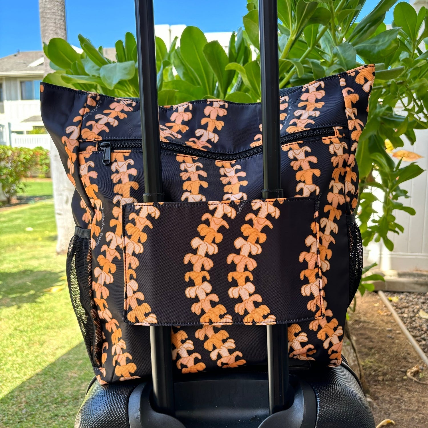 Pua kenikeni Holoholo bag with pua kenikeni lei in Kaulua by Puakenikeni Designs - Made for Hawaii Puakenikeni tote bag back view on carry-on luggage suit case