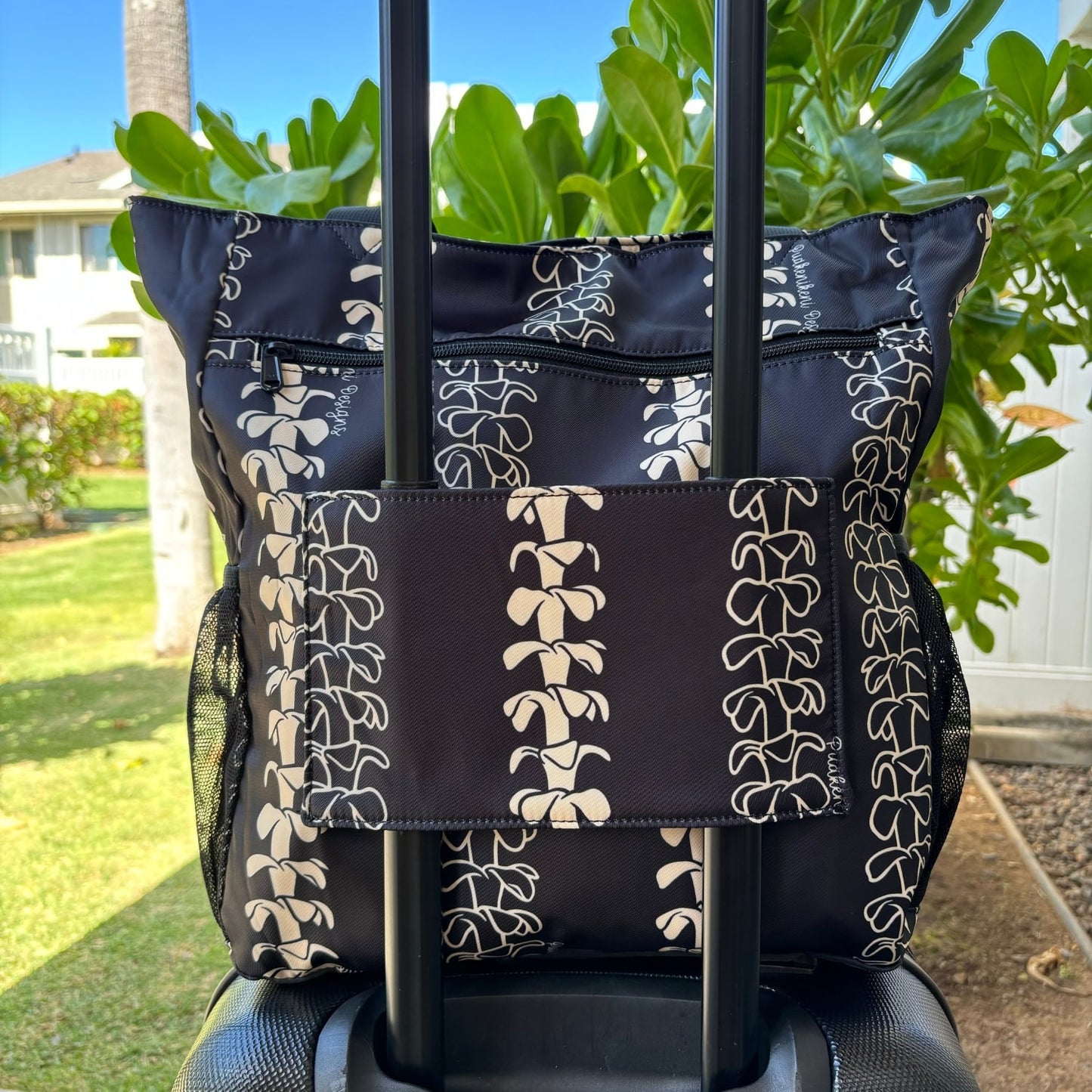 Pua kenikeni Holoholo Bag for travel from Puakenikeni Designs - use for beach, diaper bag, handbag, hula bag back view on carry-on luggage suit case