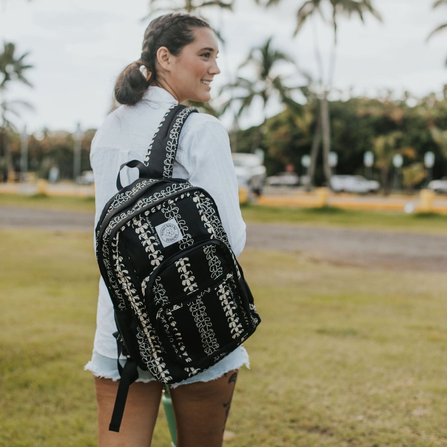 Backpack by Puakenikeni Designs, in a best selling and favorite pua kenikeni lei design, Beige Lei on model