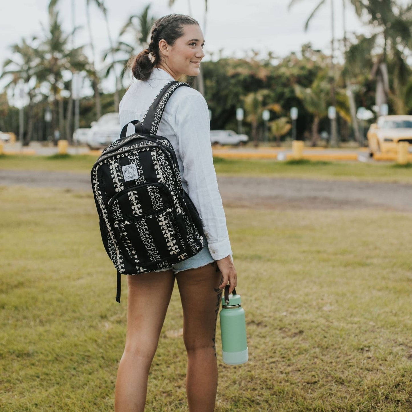 Backpack by Puakenikeni Designs, in a best selling and favorite pua kenikeni lei design, Beige Lei on model