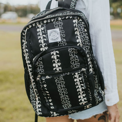 Backpack by Puakenikeni Designs, in a best selling and favorite pua kenikeni lei design, Beige Lei on model close-up