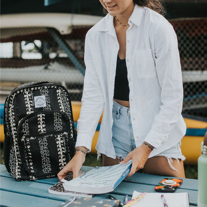 Backpack by Puakenikeni Designs, in a best selling and favorite pua kenikeni lei design, Beige Lei on table