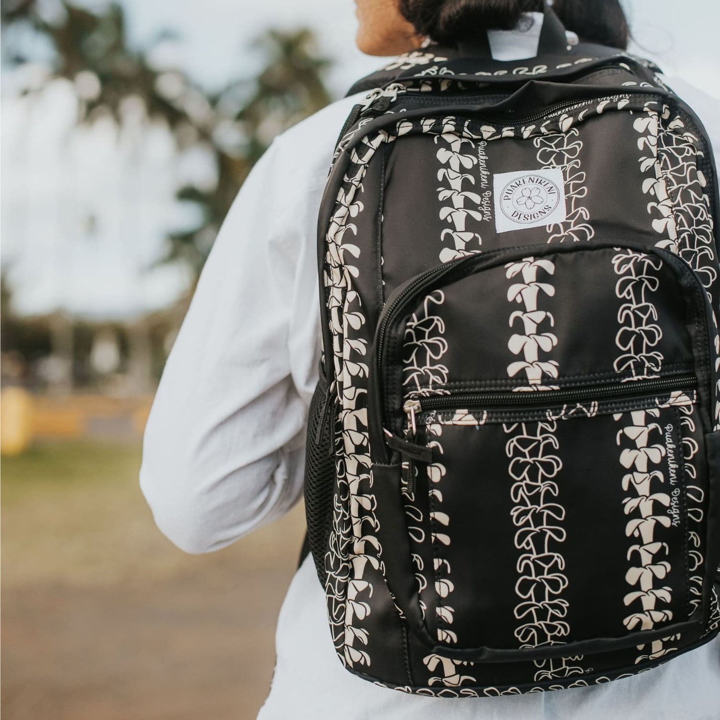 Backpack by Puakenikeni Designs, in a best selling and favorite pua kenikeni lei design, Beige Lei on model close-up