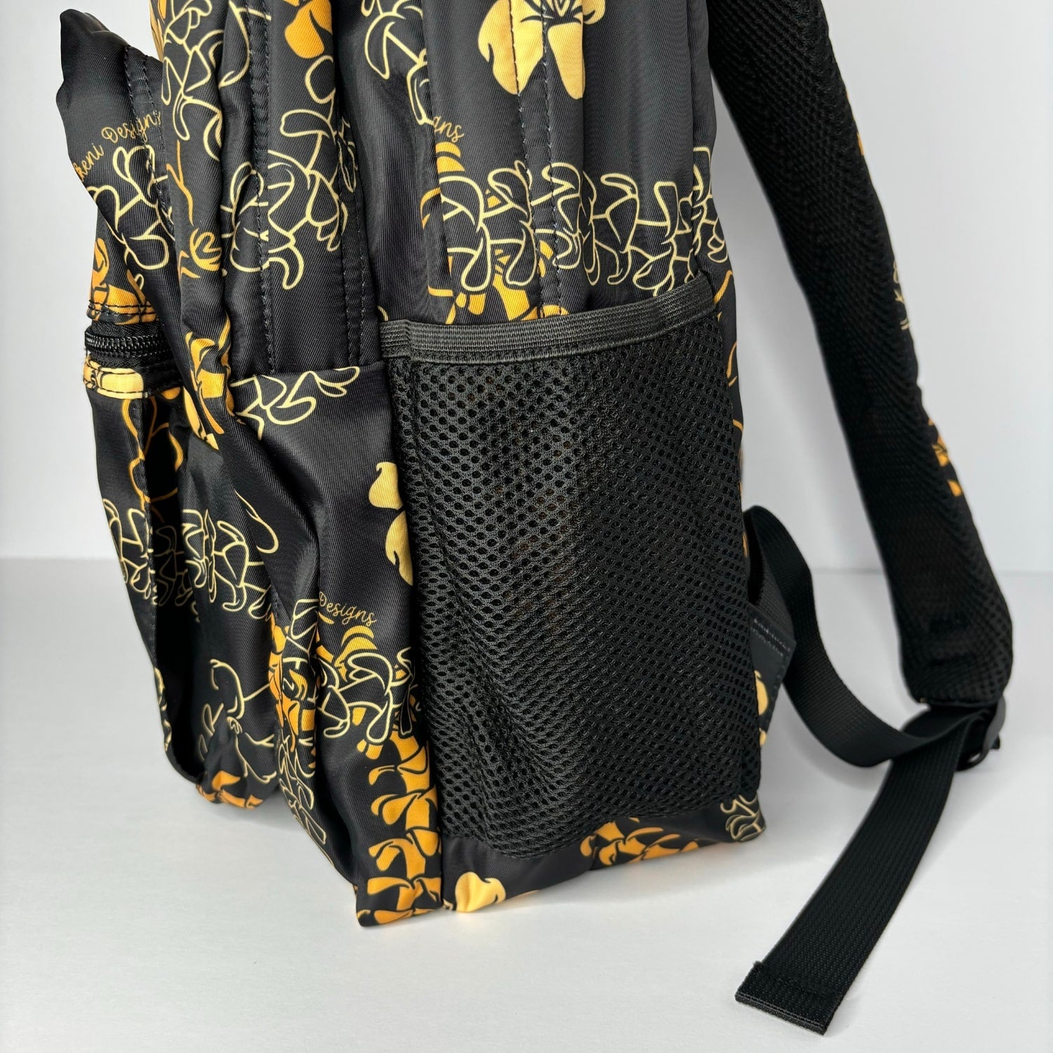 backpack for school, travel, diaper bag, with pua kenikeni lei, black and orange from Puakenikeni Designs side pocket