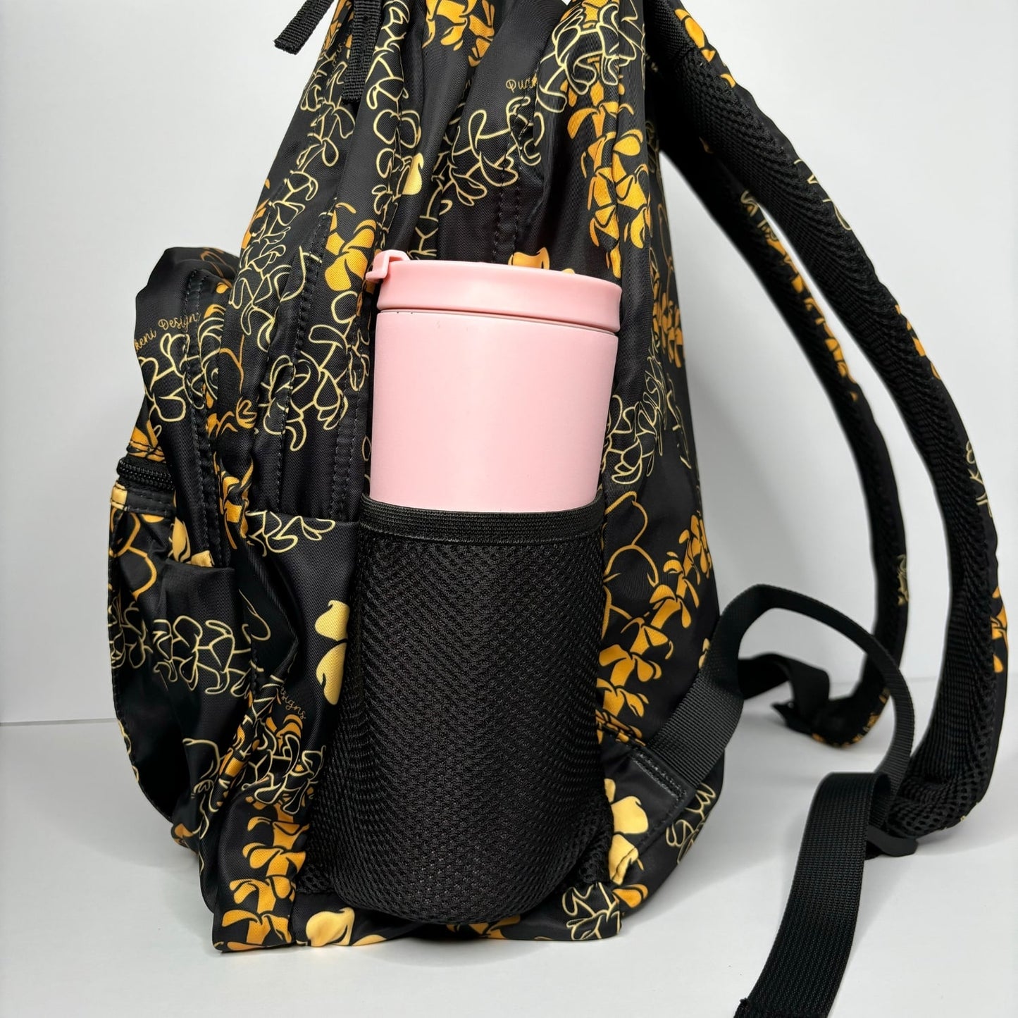 backpack for school, travel, diaper bag, with pua kenikeni lei, black and orange from Puakenikeni Designs side pocket with tumbler