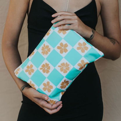 holoholo zipper pouch in turquoise checker from Puakenikeni Designs model holding close up