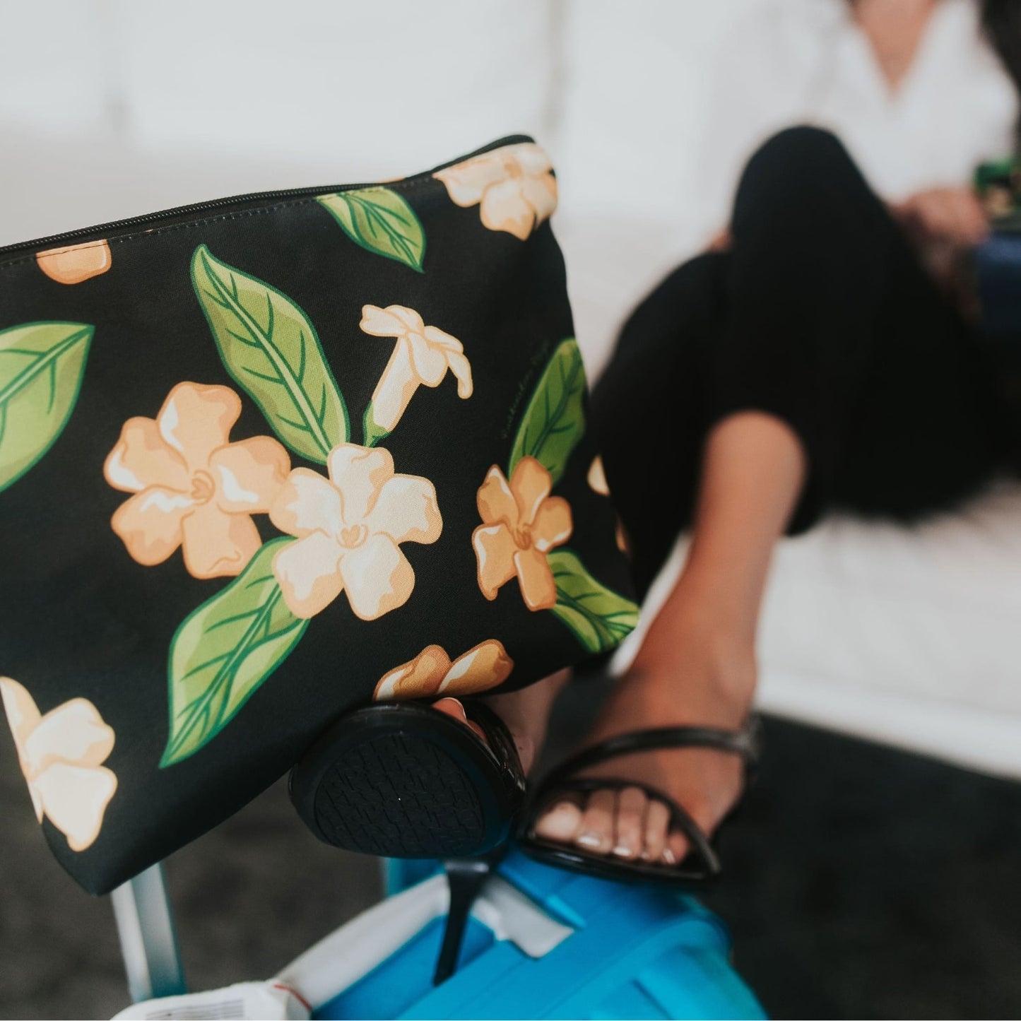 large canvas zipper pouch with pua kenikeni flowers and leaves from Puakenikeni Designs close up on luggage during travel