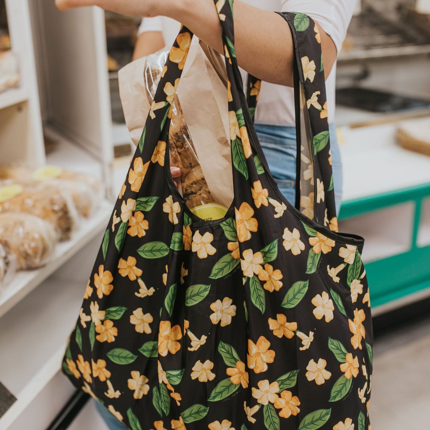 large foldable reusable shopping bag with puakenikeni flowers and leaves from Puakenikeni Designs - close-up grocery shopping