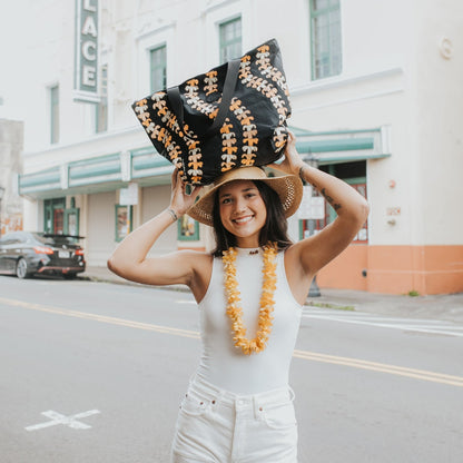 medium tyvek tote kaulua black with pua kenikeni lei from Puakenikeni Designs on model