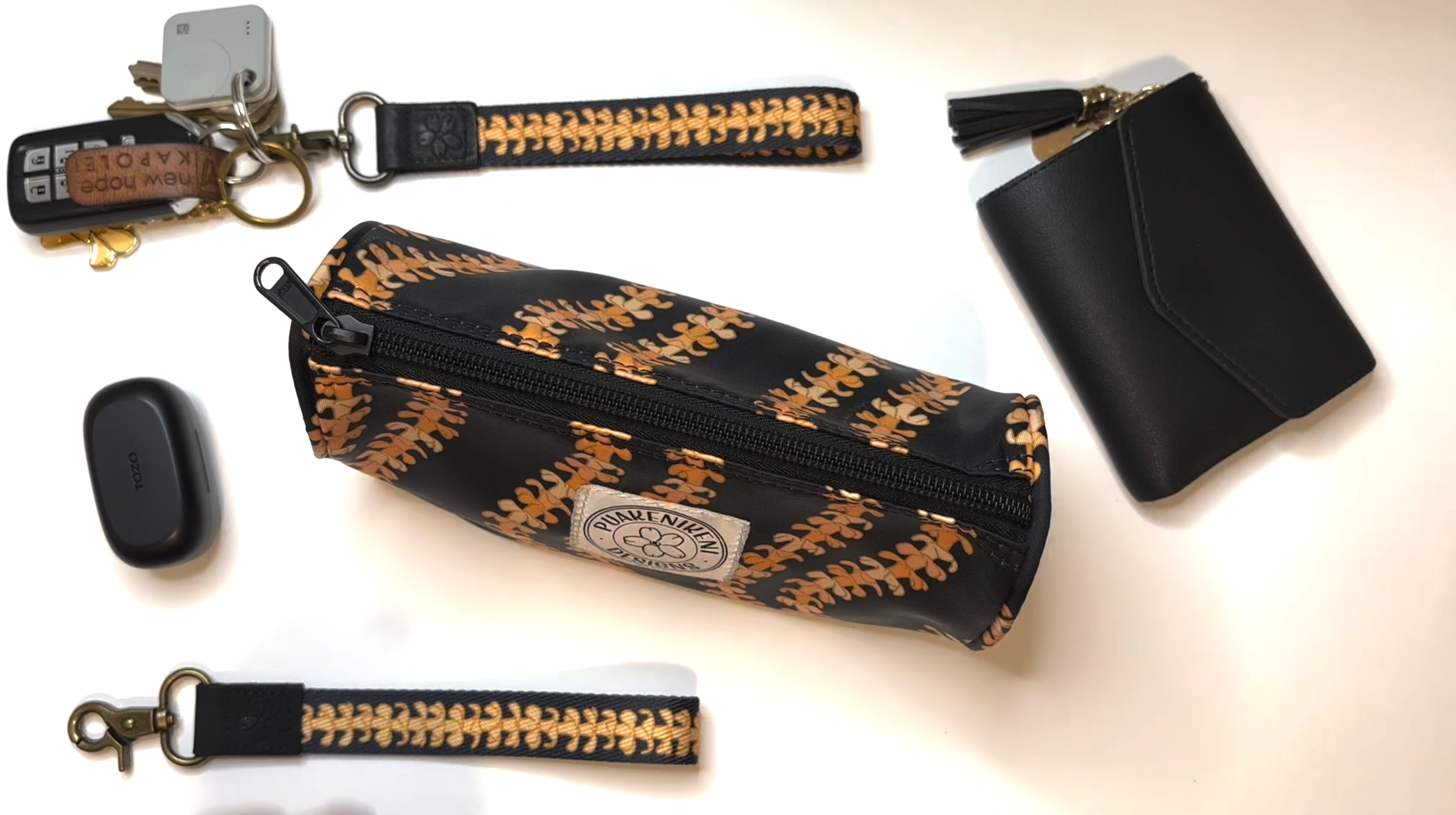 Load video: Grab-and-Go Set in Kaulua Black, a bundle including the Mini Zipper Pouch and Wristlet Keyfob making a clutch set